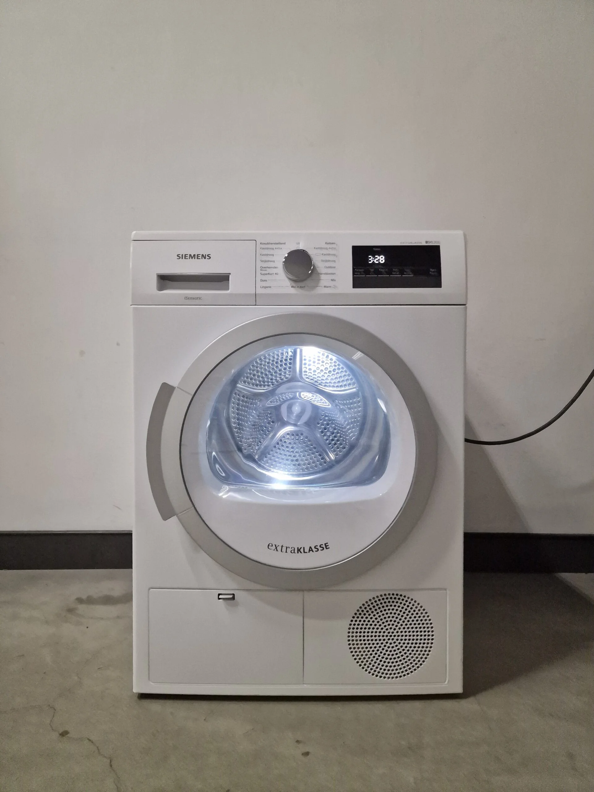 Siemens iQ300 WT45H281NL warmtepompdroger met autoDry, easyClean-filter, softDry trommelsysteem, wolkorf en 7 kg laadvermogen in witte uitvoering.